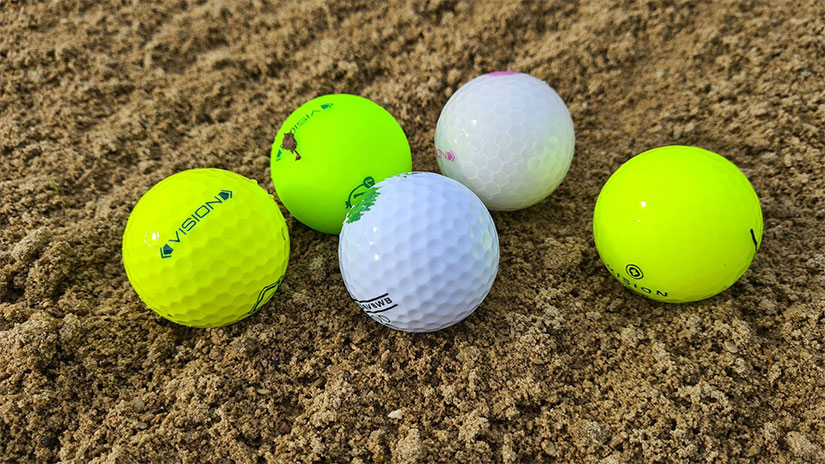 Verschiedene Vision Golfball Modelle auf Sand